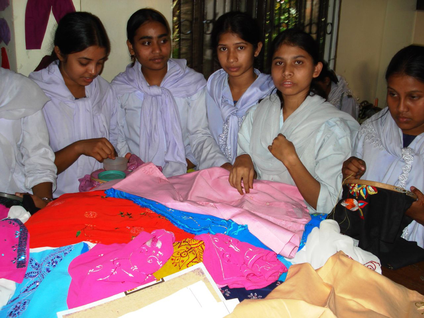 Young women work on textiles.
